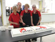 staff cutting free cake for Opening Day celebration